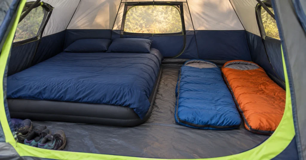 Inside the Coleman Sundome 4-person tent with a queen air bed and two kids' sleeping bags